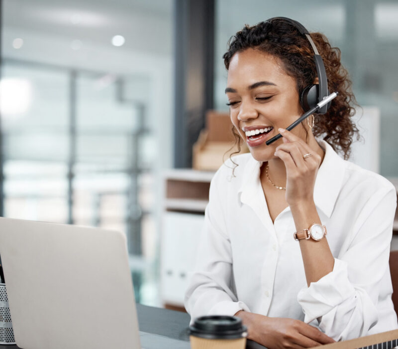 Cropped shot of an attractive young female call center agent working at her desk in the office.